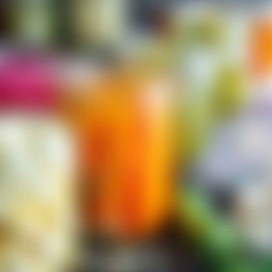 Assortment of colorful pickled vegetables in glass jars